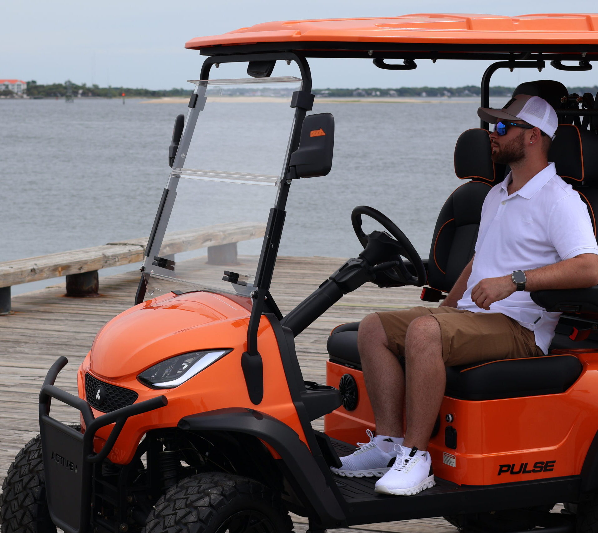 Back Bay Rentals golf cart parked beside the Delaware Bay.