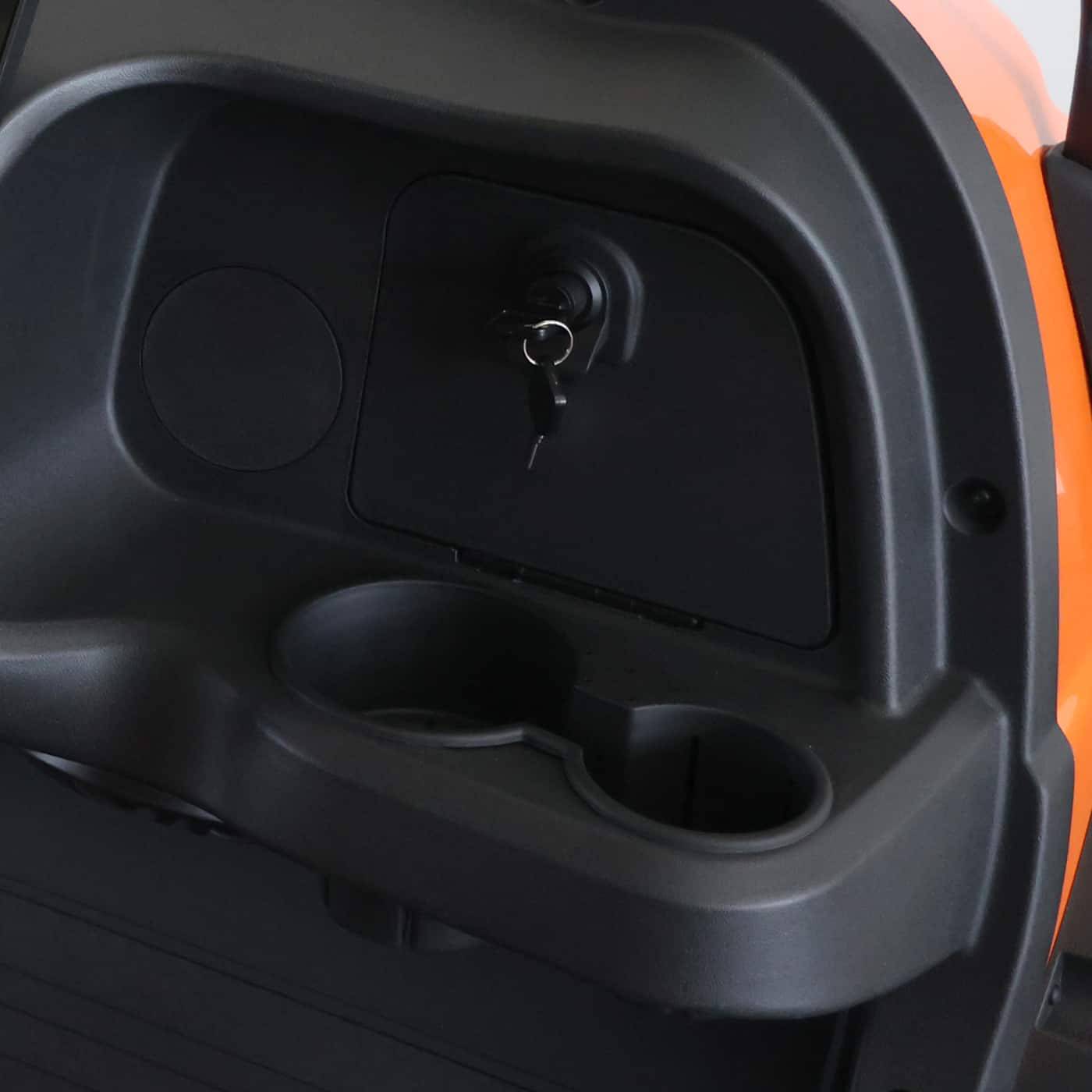 Close-up of the ignition area, cup holders, and small storage compartment in the six-seater golf cart.