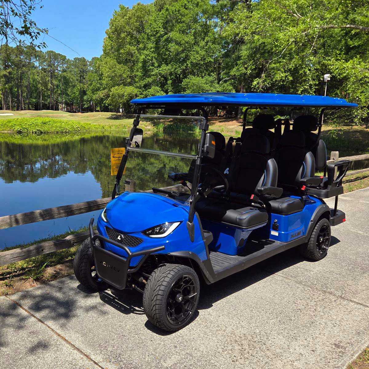 Side view of the blue six-seater Bintelli ActivEV Pulse golf cart with three rows of seating.