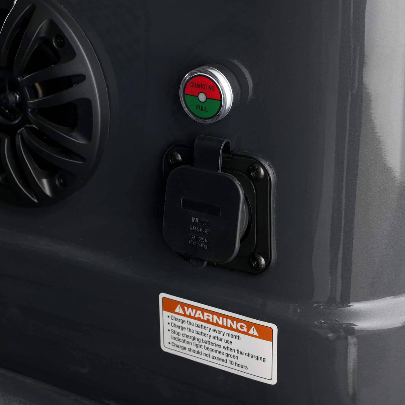 Close-up of the charging port and speaker area on the six-seater golf cart.